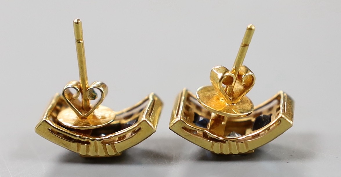 A modern pair of yellow metal, sapphire and diamond cluster set curved rectangular earrings, 14mm, gross weight 5.2 grams.